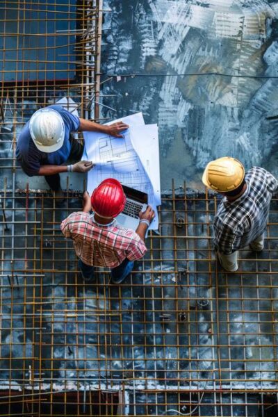 construction-workers-blueprints-laptop-construction-site-ar-916-job-id-b3f05e486d97416badec36abc7c2ed8d-448x800